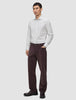 En mand iført en Elevated Shirt Regular Light Grey Striped, mørke bukser og mørke loafers.