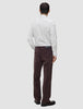 Bagfra-billede af en person iført en Elevated Shirt Regular i lysegrå striber, mørkebrune bukser og mørke loafers.