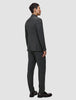 En mand set bagfra iført en Motion Blazer Slim i farven Pepper Grey og mørke loafers i klassisk dansk design.
