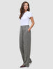En kvinde i en hvid T-shirt og Women Ashryn Pants Wide Domino Herringbone-bukser i et klassisk dansk design.