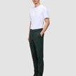 En mand i en hvid T-shirt, Ease Pants Slim Northern Pine med 360°-stretch og mørke læderstøvler.
